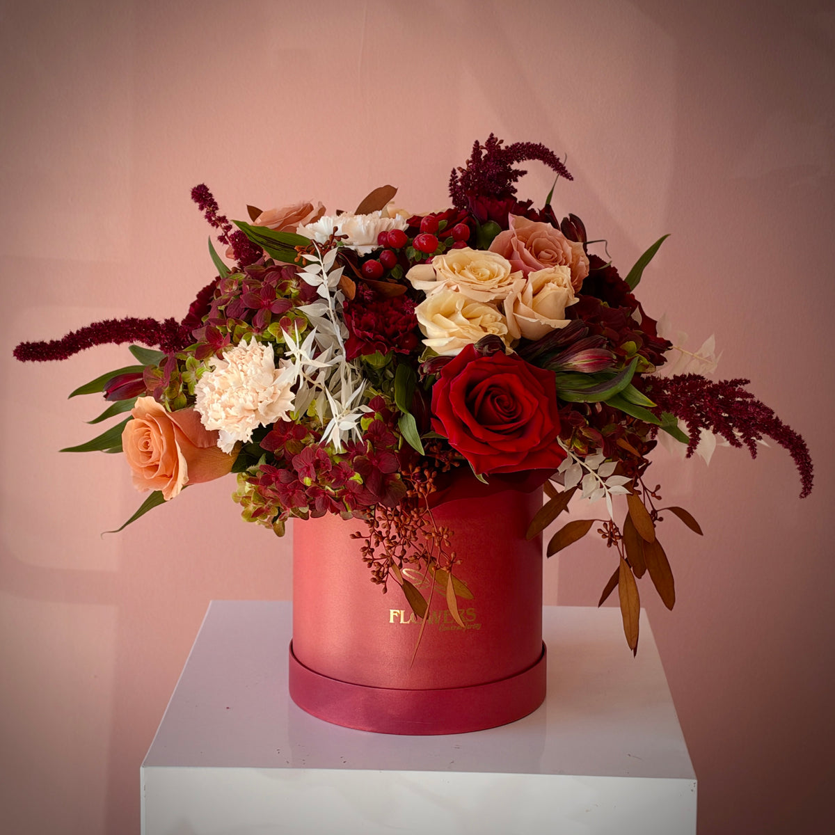 FREA red, burgundy and beige flower box in a blush round box