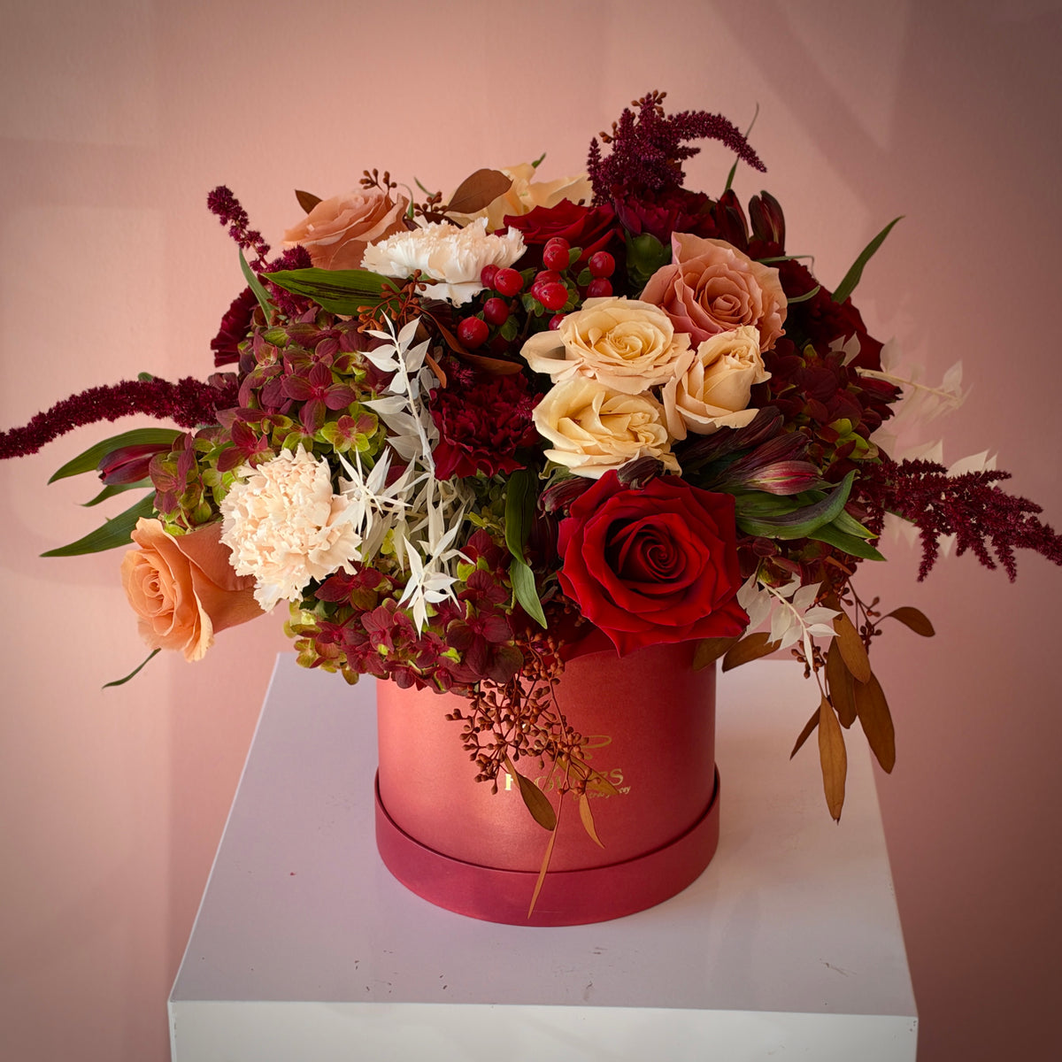 FREA flower box side view with white carnations, red berries and blush roses