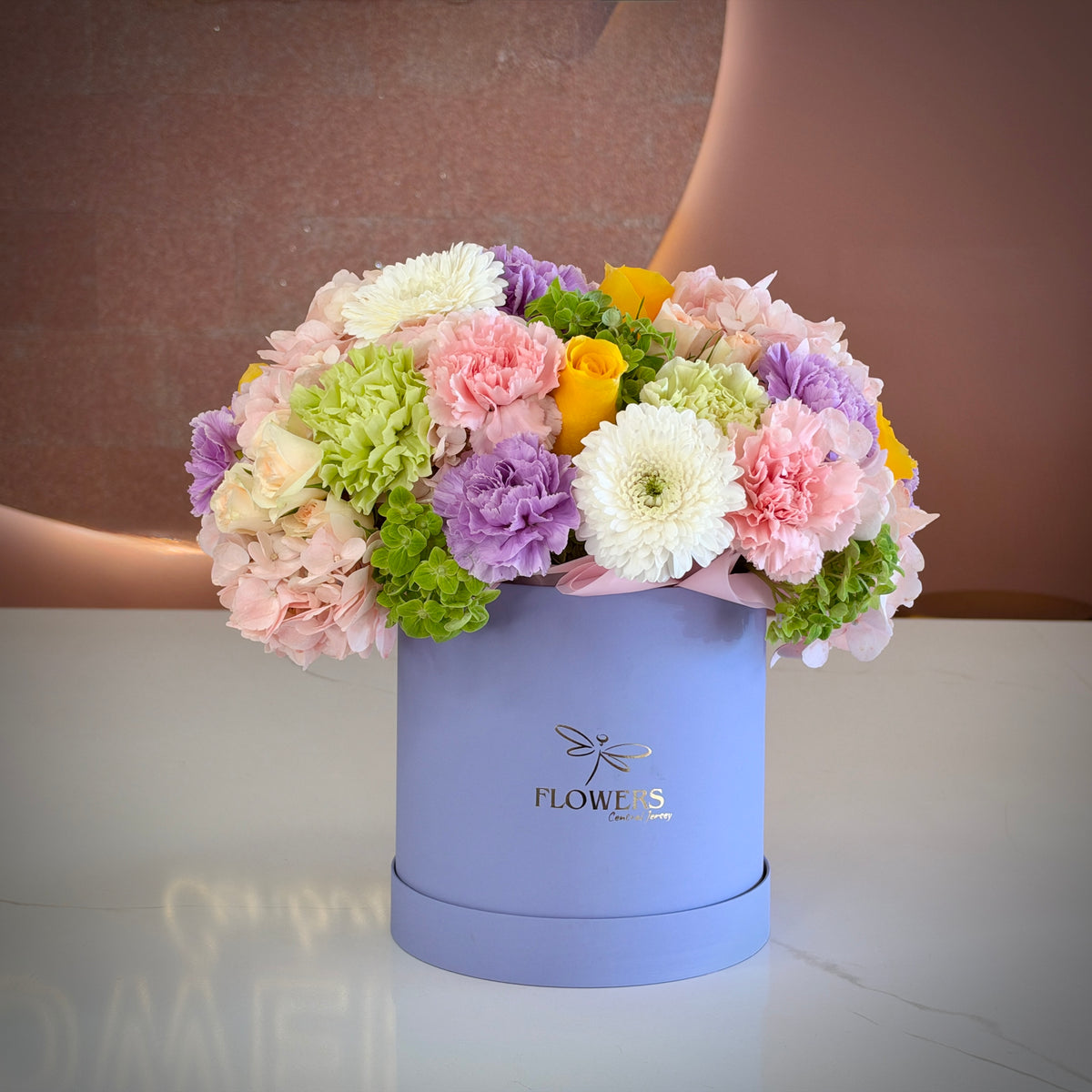 Juicy flower box with pink carnations, lavender blooms and yellow roses