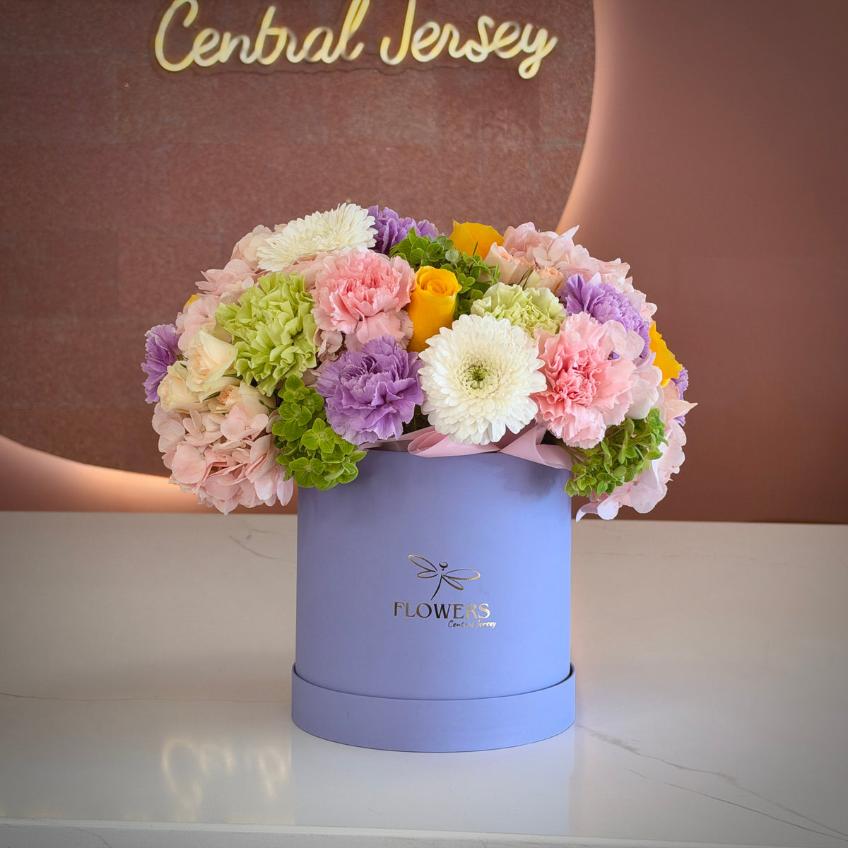Juicy pink, lavender, yellow and green flower box in a lavender round box